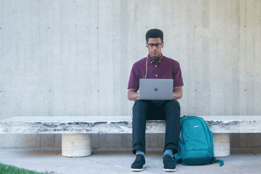 How to Choose the Right MCAT Tutor or Community for Your Learning Style 2 A student learning on their own on a bench